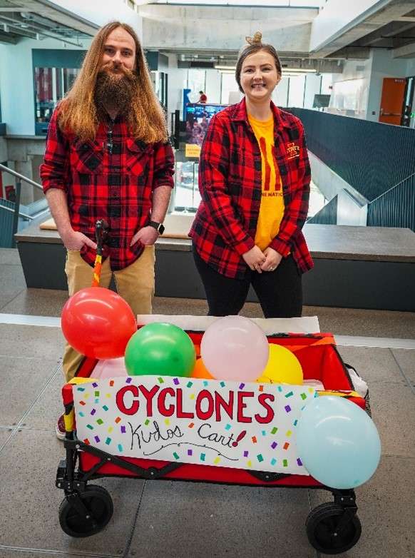 Two SiCTR employees standing behind cart
